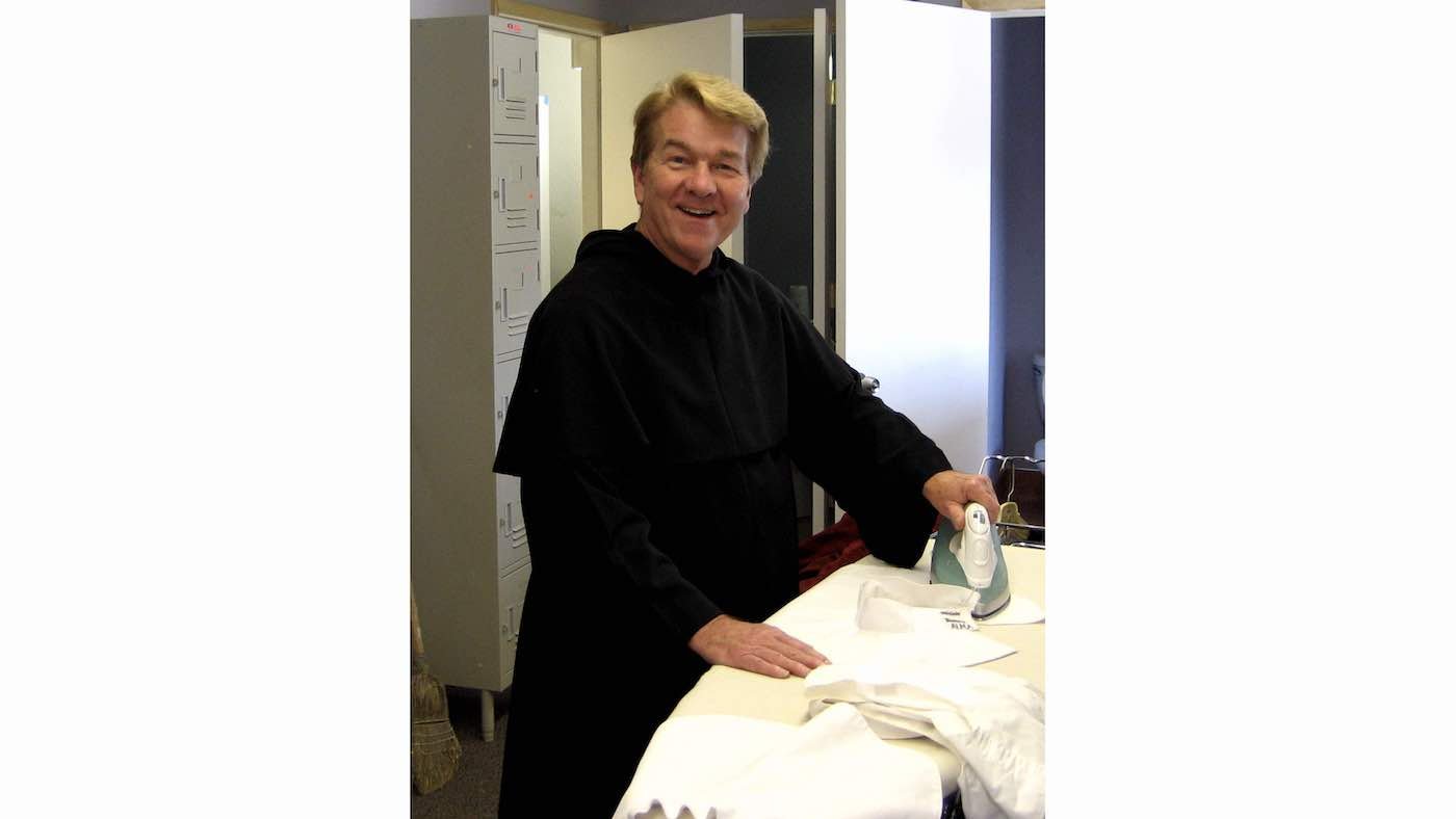 A photo of Dan Goggin ironing.